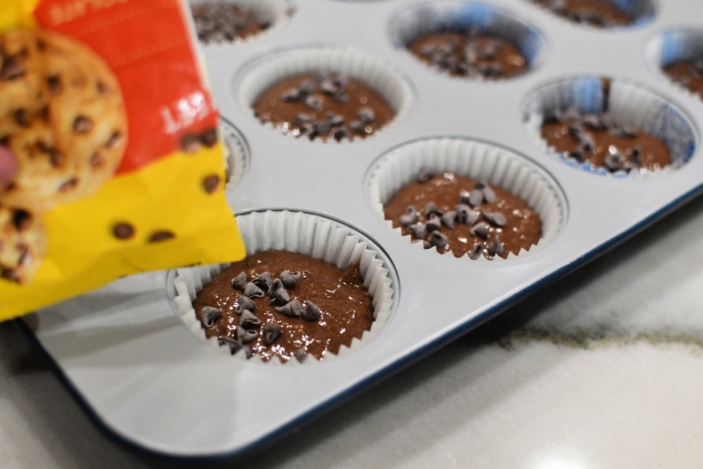 adding a few chocolate chips to the tops of muffins
