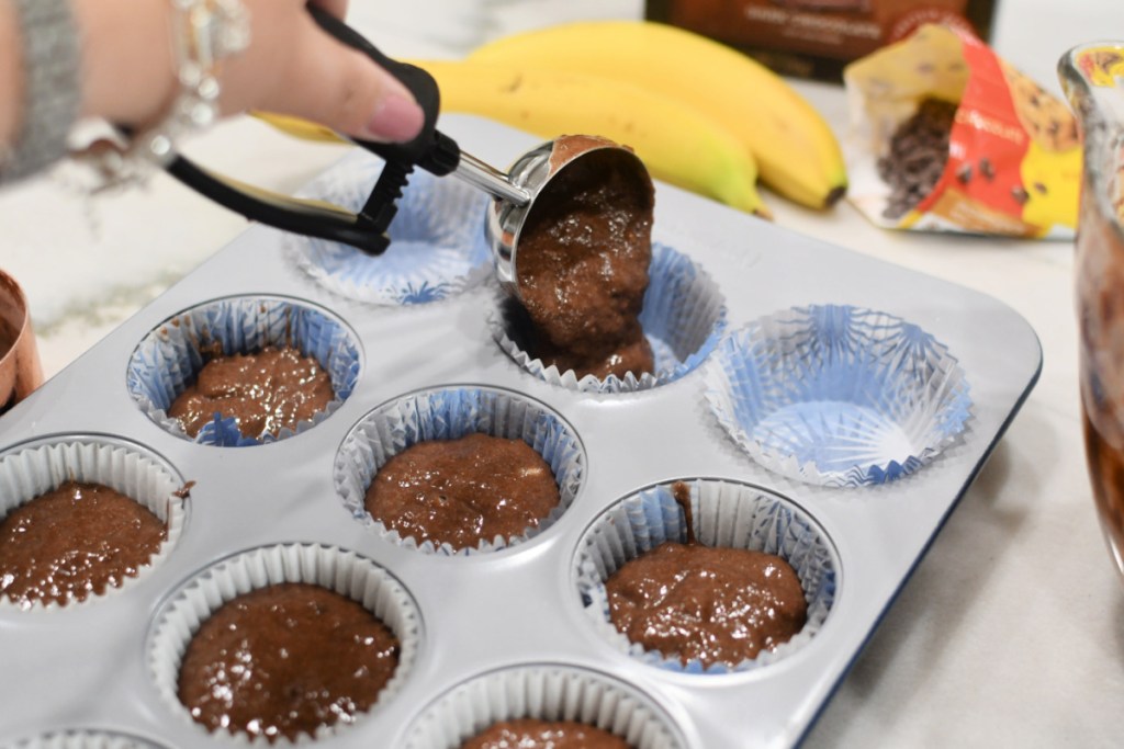 adding chocolate batter to muffin pan
