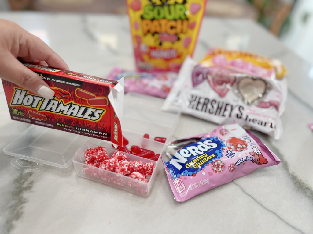 adding candy to valentine's snackle box