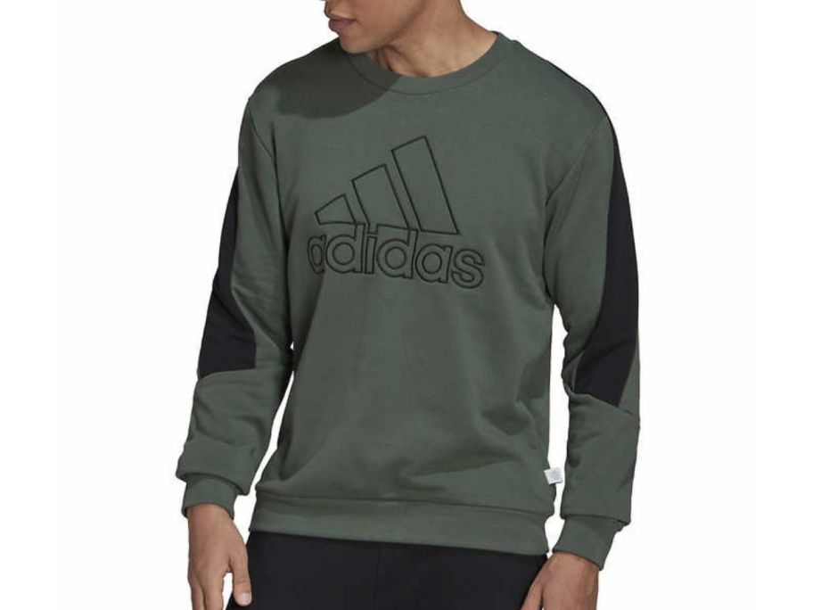 A man wearing an adidas Men’s Crewneck Sweatshirt