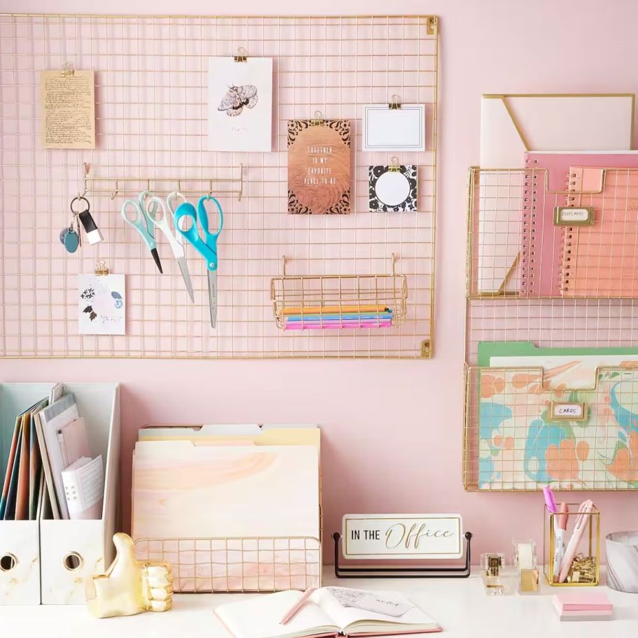 a desk shown with gold wire organization accessories