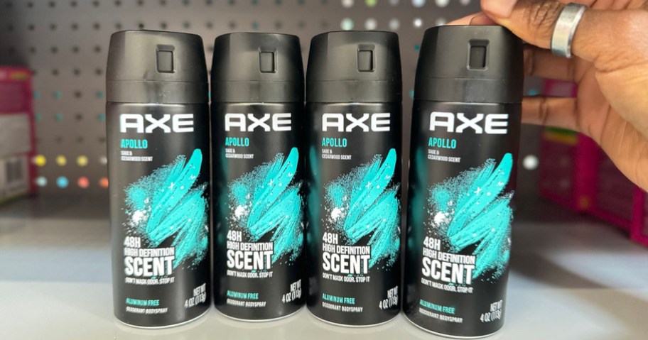 4 axe apollo body spray cans sitting on shelf