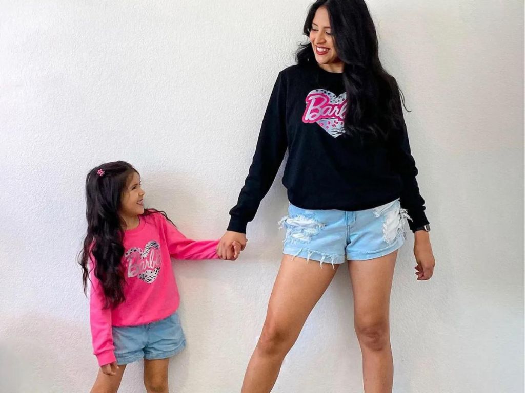 mom and daughter wearing barbie sweatshirts