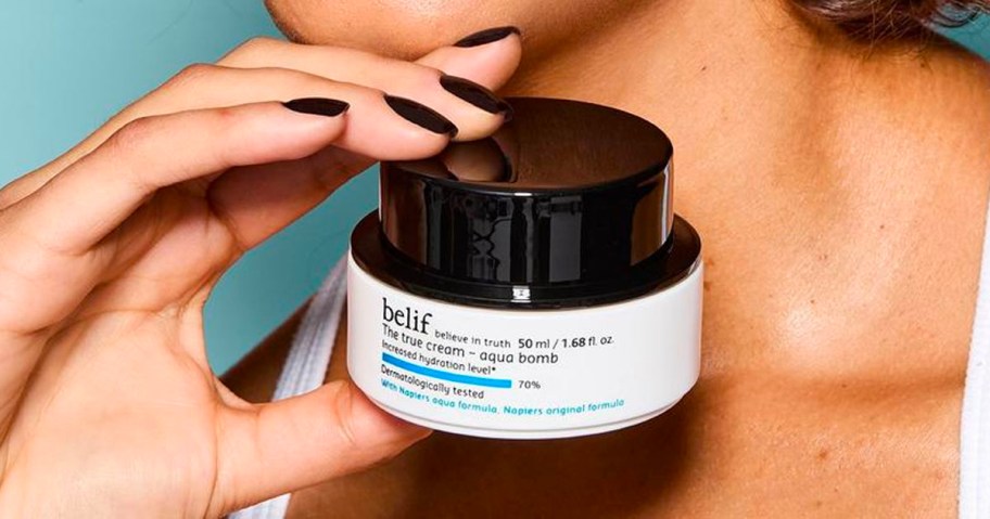 hand holding belif aqua bomb moisturizer