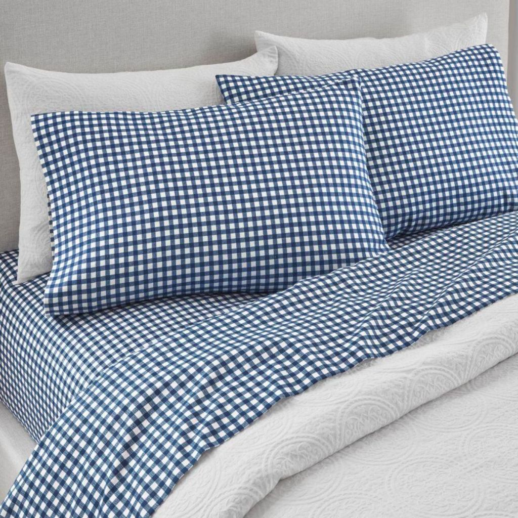 blue gingham flannel sheets on a bed with a white duvet