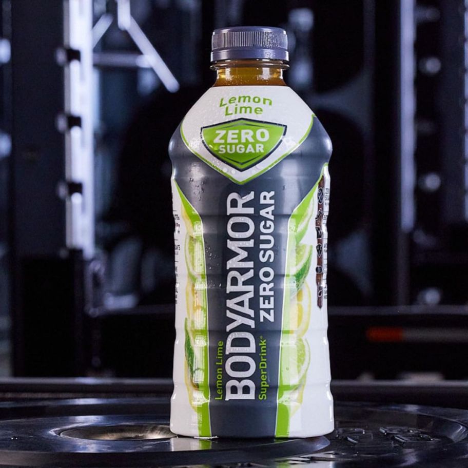 a bottle of lemon lime bodyarmor super drink with workout machines in the background