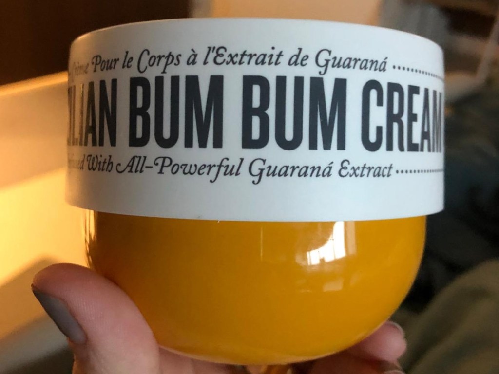 holding a jar of Brazilian Bum Bum cream