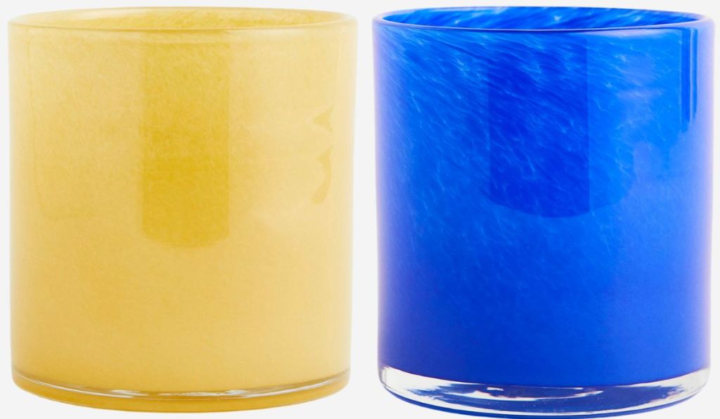 yellow glass candle lantern and blue tea light holder - stock image on white background