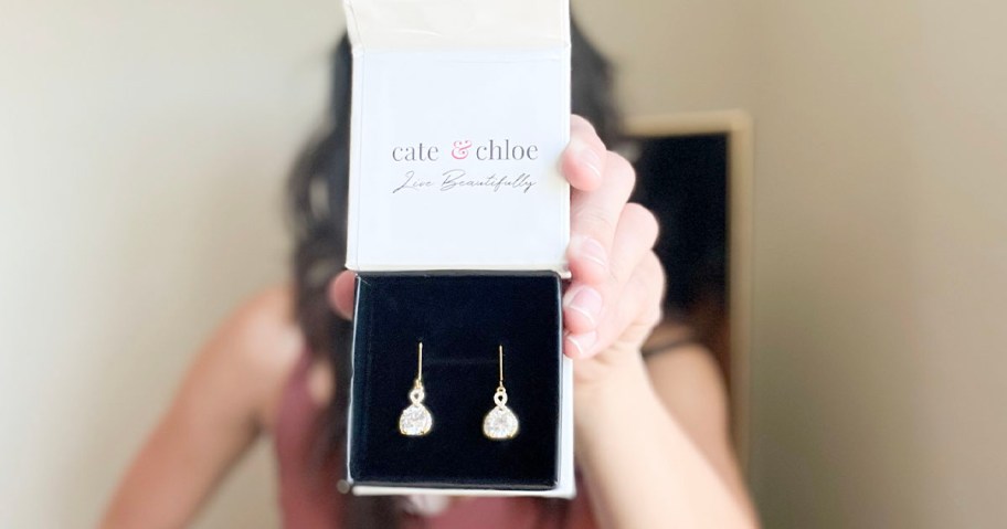 woman holding cate and chloe drop earrings box 