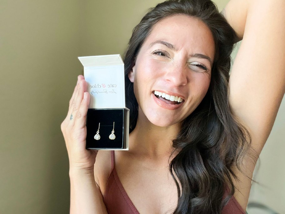 woman holding cate and chloe earrings box