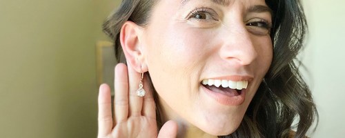 woman wearing diamond drop earrings