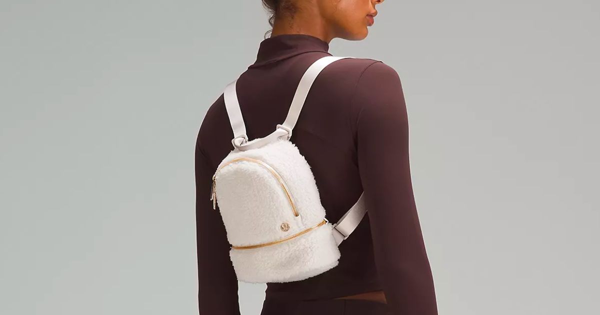 a woman wearing a white city adventurer backpack
