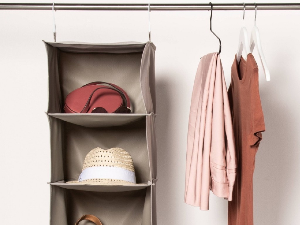 closet organizer with items inside and clothing