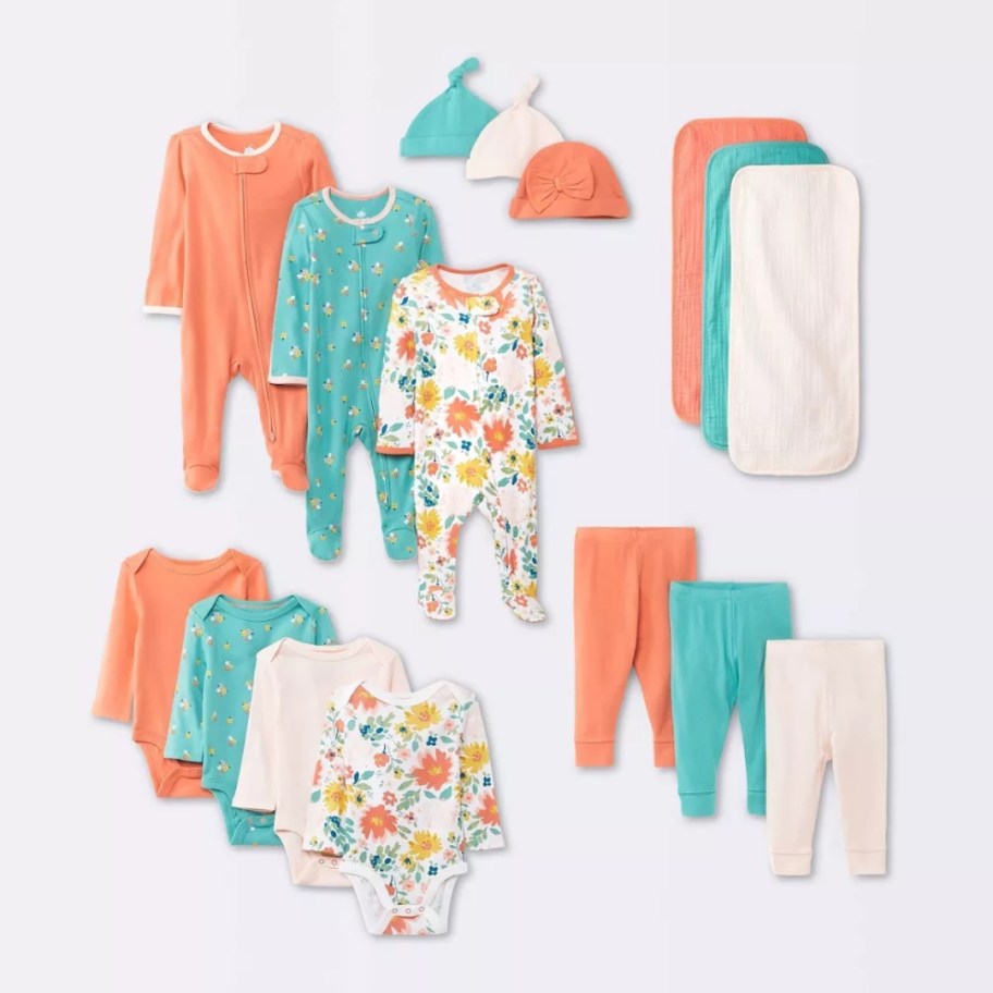 image of various baby girl's clothing items and burp clothes in floral colors, greens, oranges, peach, off white colors