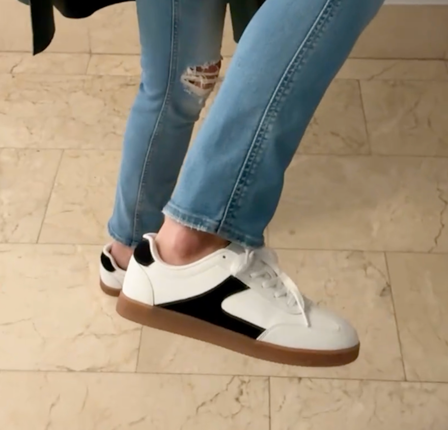close up of women's black and white sneakers 