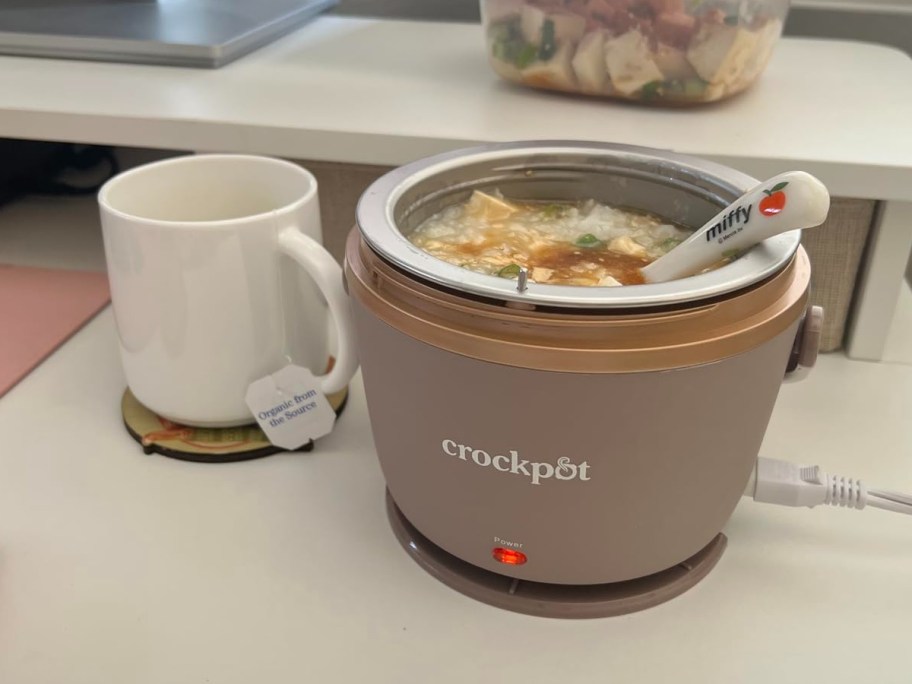 crockpot lunch crock sitting next to a coffee mug