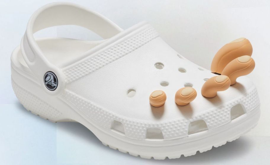 a white croc clog with a set of jibbitz toes in shade 1