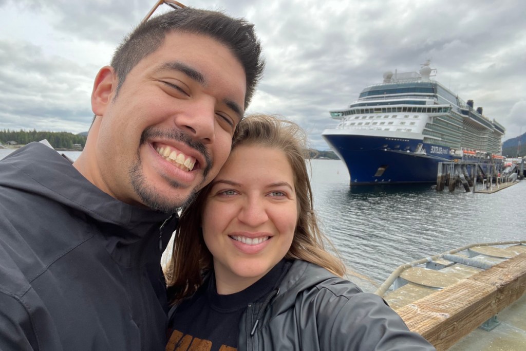 two people in front of a cruise ship