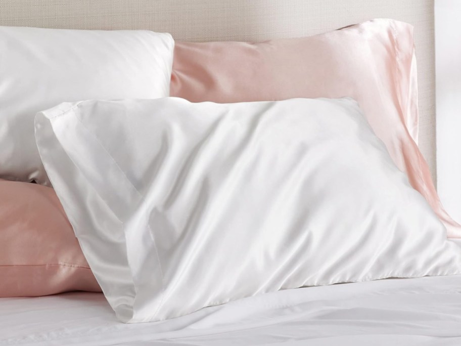 display of four silk pillows in white and pink