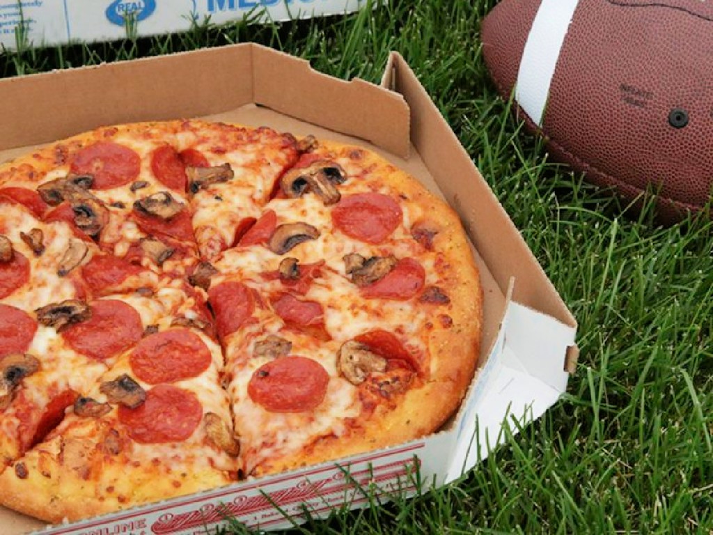 domino's pizza and football on grass