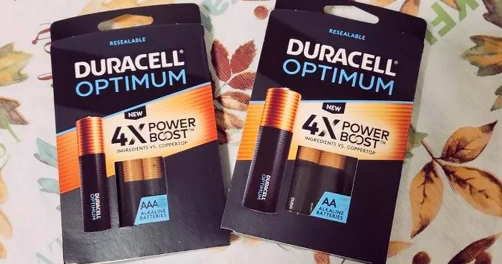 AA and AAA duracell batteries packs laying on table cloth