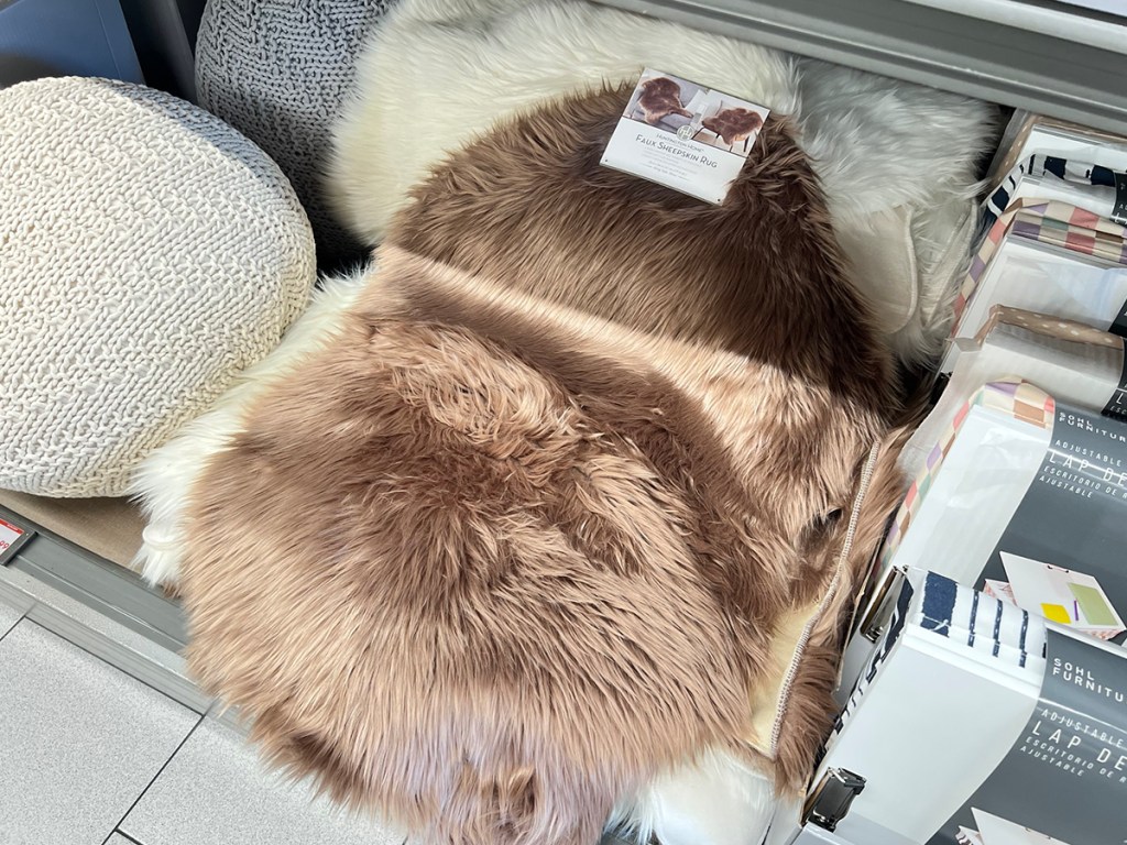 brown sheepskin rug laying on shelf in aldi store