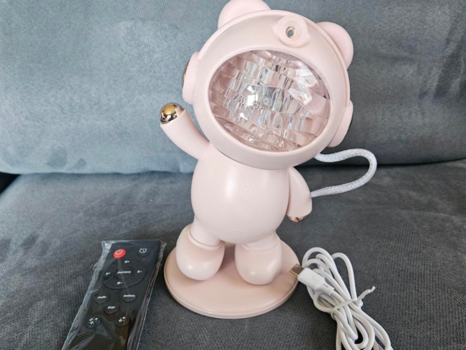 pink astronaut projector with remote and power cord