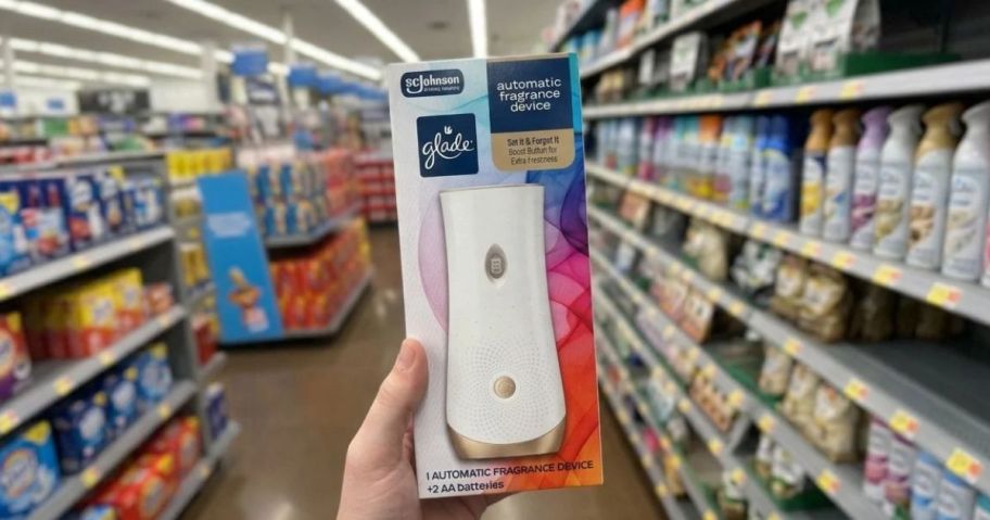 hand holding a glade device in-store
