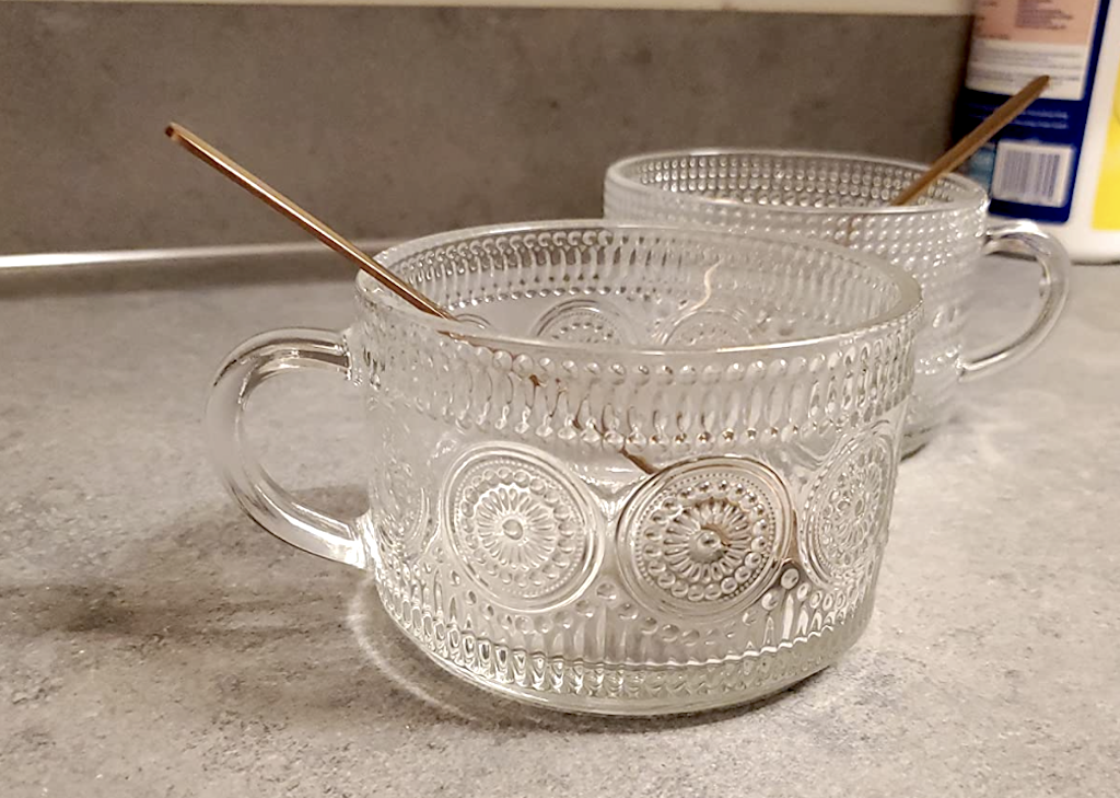 two glass coffee mugs with spoons