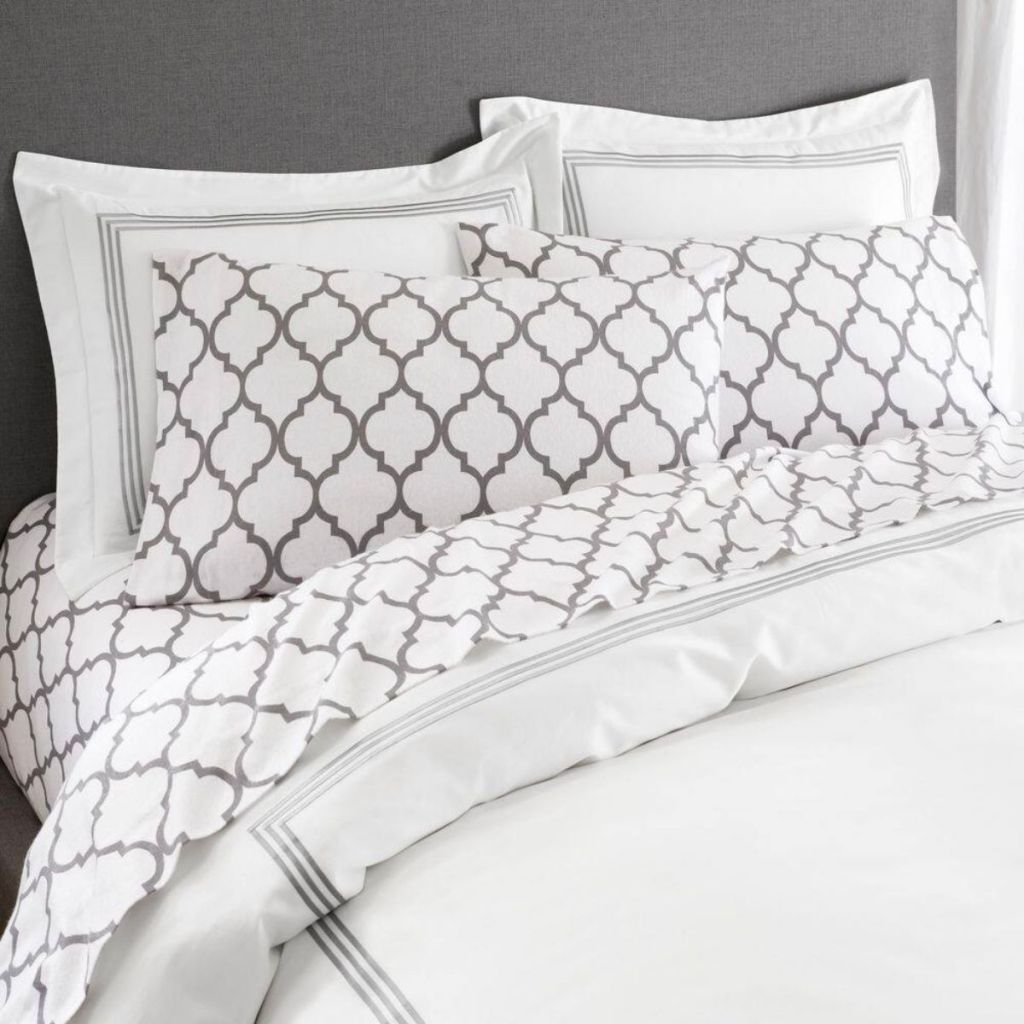 gray trellis sheet set on a bed with a white duvet
