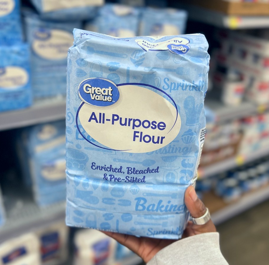 holding a bag of flour at Walmart