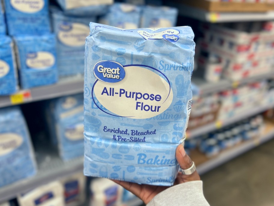 holding a bag of flour at Walmart