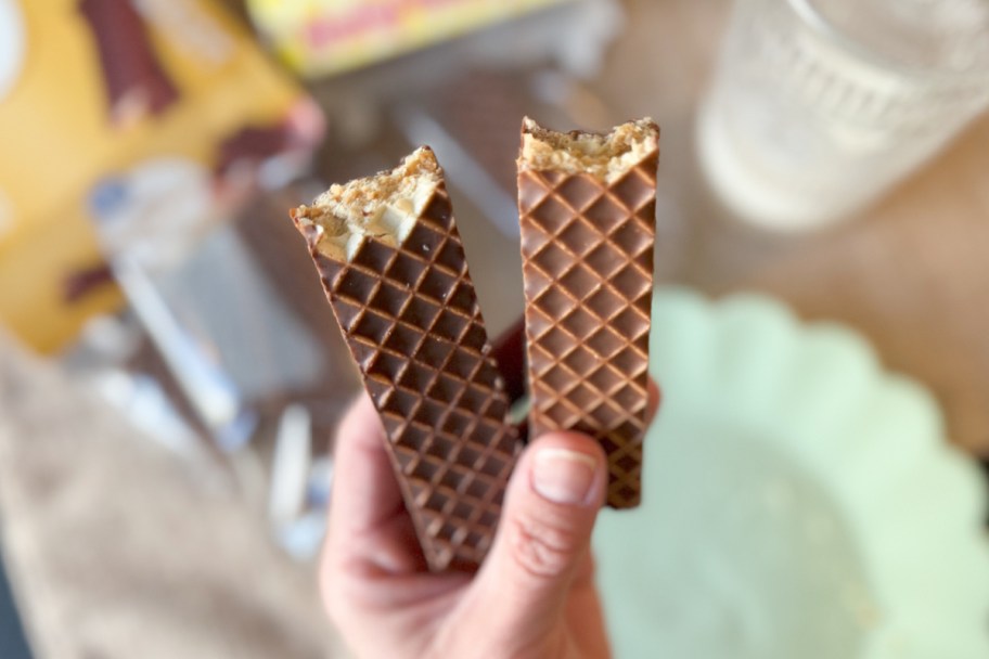 hand holding two peanut butter bars with bite taken out