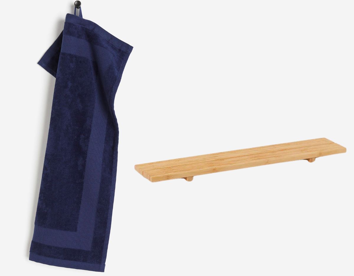 blue velour guest towel on a peg and a bamboo bath shelf - stock images