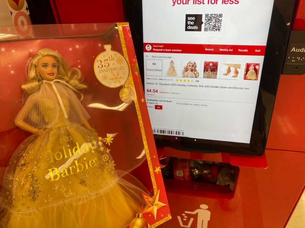 hand holding Barbie 13 Signature 2023 Holiday Collector Doll w_ Golden Gown in front of target price checker-2