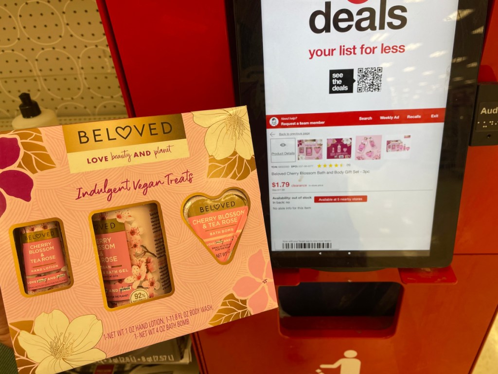 hand holding Beloved Cherry Blossom and Tea Rose 3 Piece Set in front of target price checker
