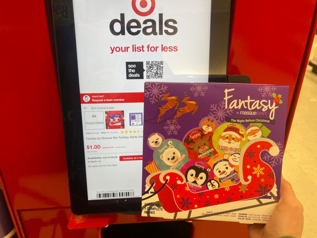 hand holding Fantasy By Masque Bar The Night Before Christmas 5 Pack in front of the price check at Target