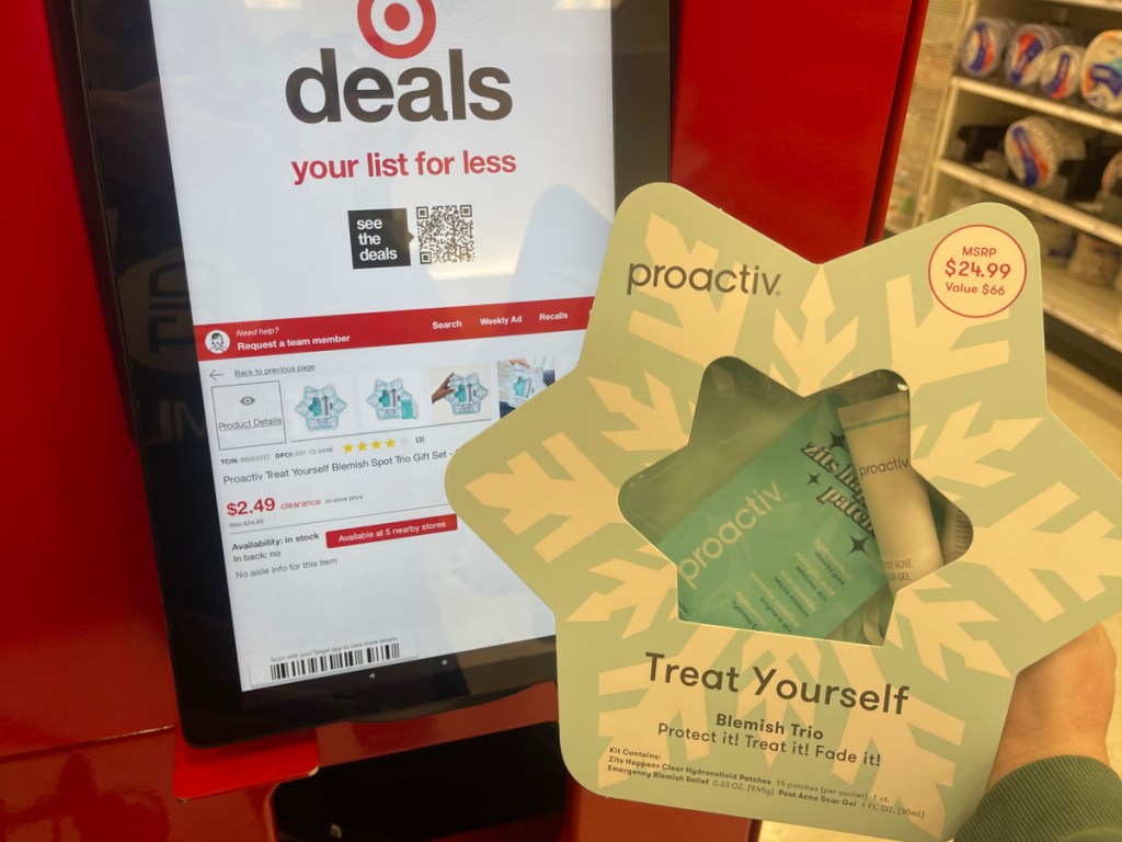 hand holding Proactiv Treat Yourself Blemish Spot Trio Set in front of the price check at Target