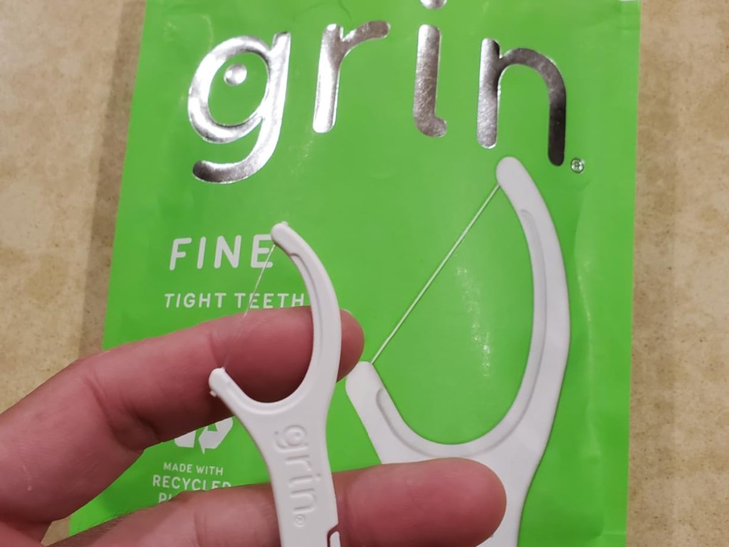 hand holding grin tooth picks
