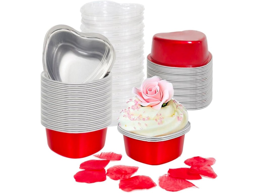 heart shaped red tins with lids, and rose petals on table