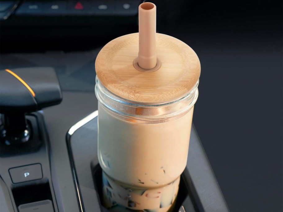 mason jar glass in car cup cholder with coffee inside