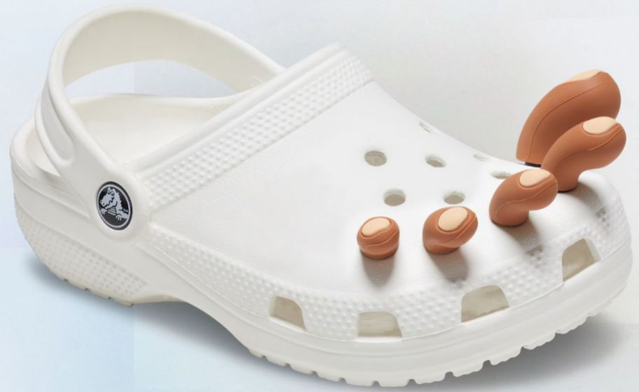 a white croc clog with a set of jibbitz toes in shade 3