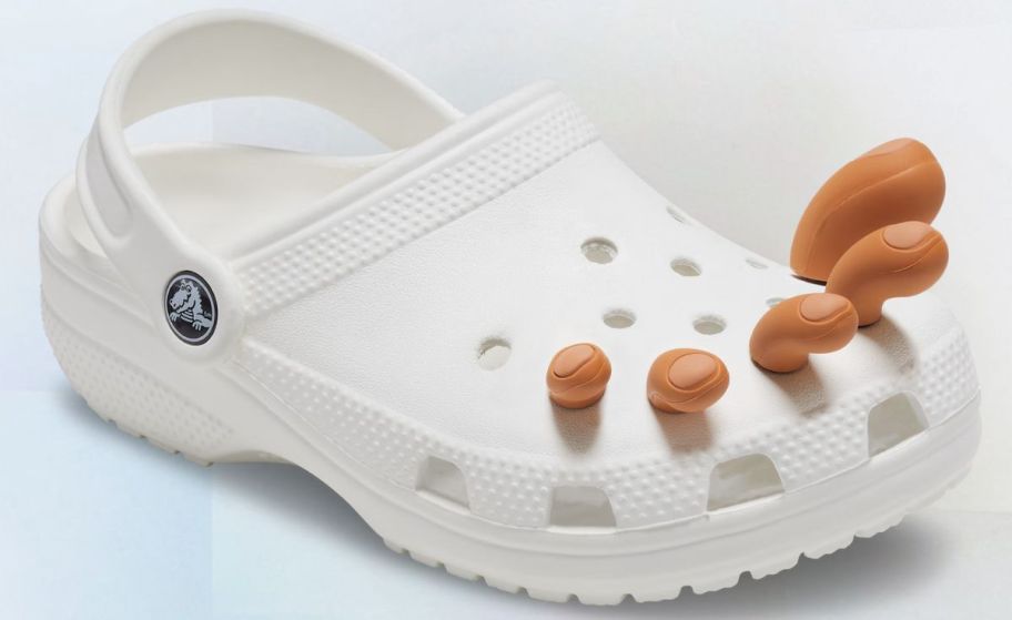 a white croc clog with a set of jibbitz toes in shade 2