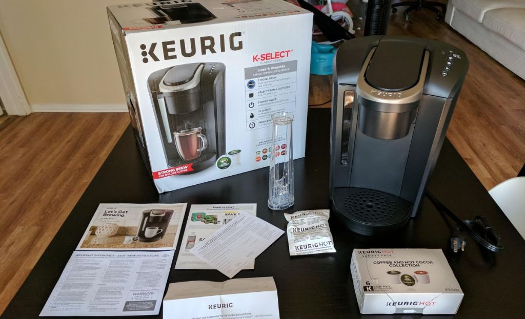 keurig coffee machine on table next to box and accessories