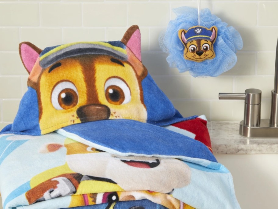 paw patrol hooded towel and loofah on a sink
