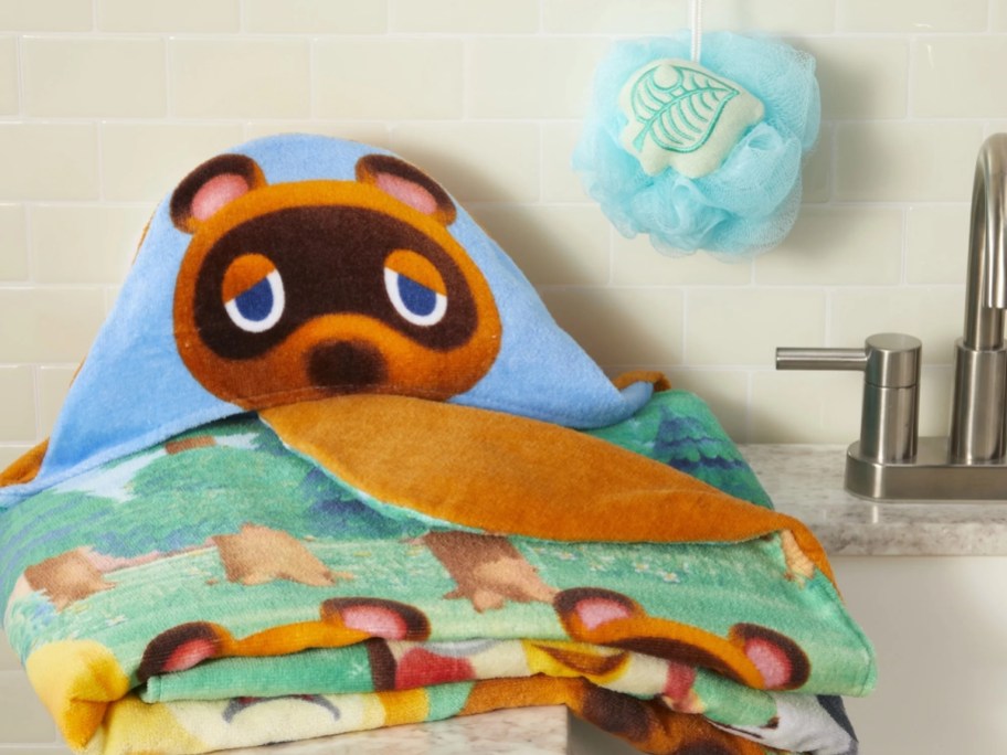 animal crossing hooded towel and loofah on a sink