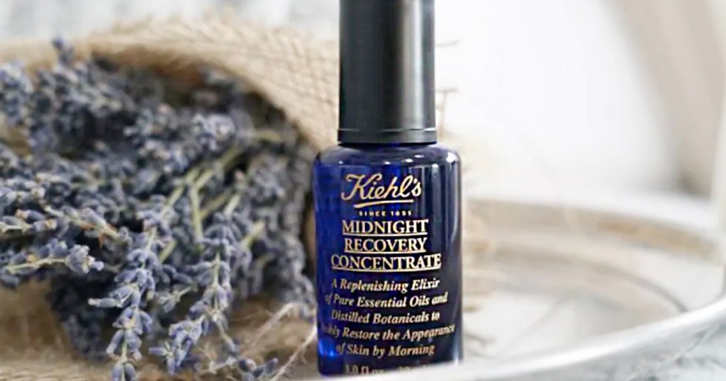 kiehls 1851 midnight recovery face oil bottle next to lavendar