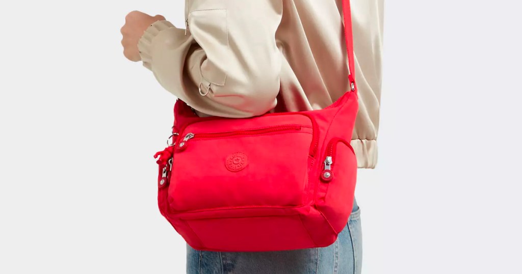 woman wearing red kipling bag