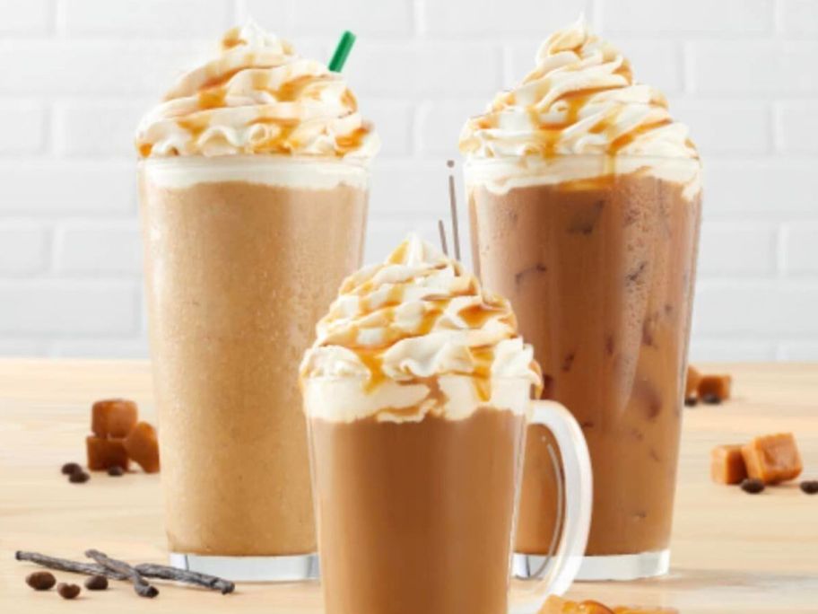 3 glasses of latte's with whipped cream and caramel topping