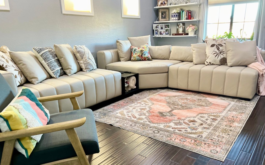piano white leather sectional couch with pink rug